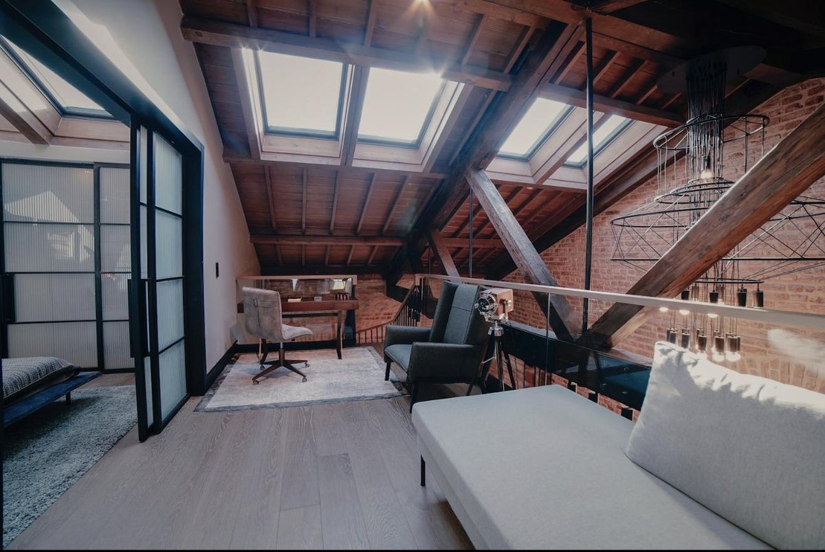A loft office with skylights and exposed brick
