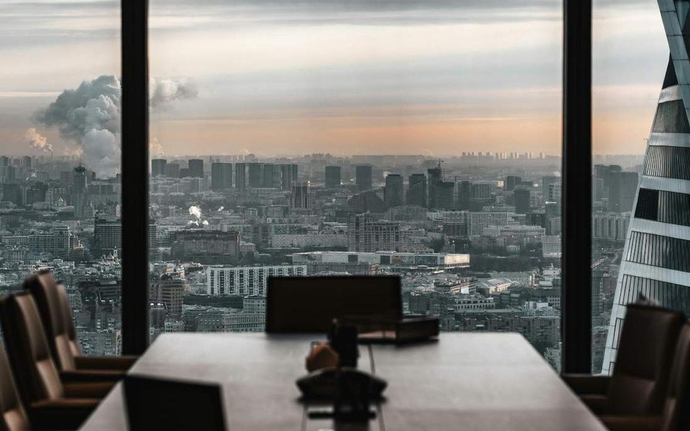 A boardroom table looking out over a city skyline