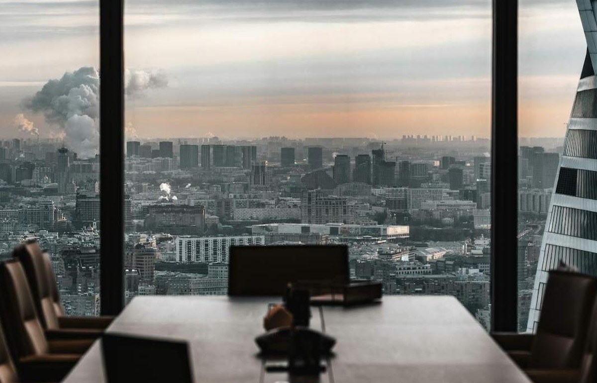 A boardroom table looking out over a city skyline