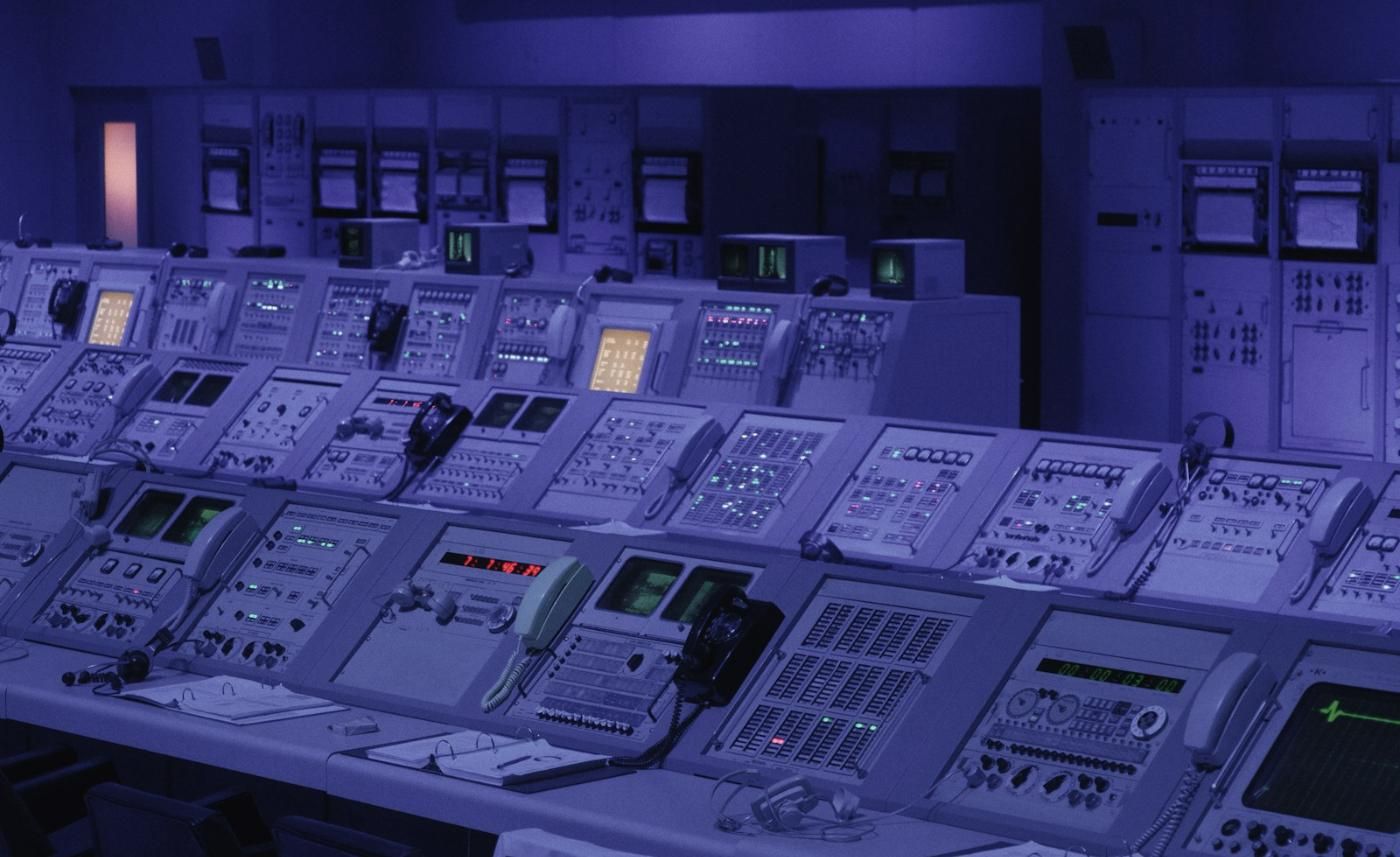 A control room lit in blue
